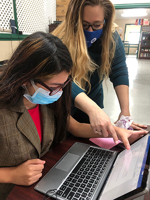 AmeriCorps member Whitney Holloway works with a Georgia 4-H'er on computer skills.