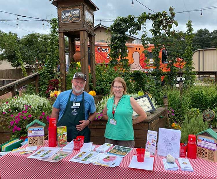 Guy person and lady person help out at a 2021 counting event at the Slow Pour Brewery in Gwinnett County.
