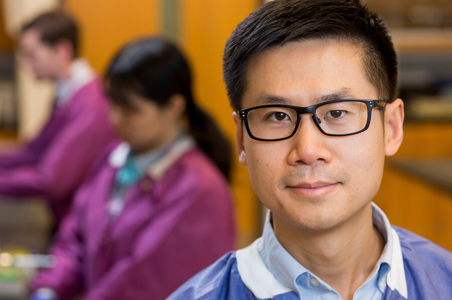 UGA researcher Xiangyu Deng in his lab on the UGA Griffin campus, with students working in the background