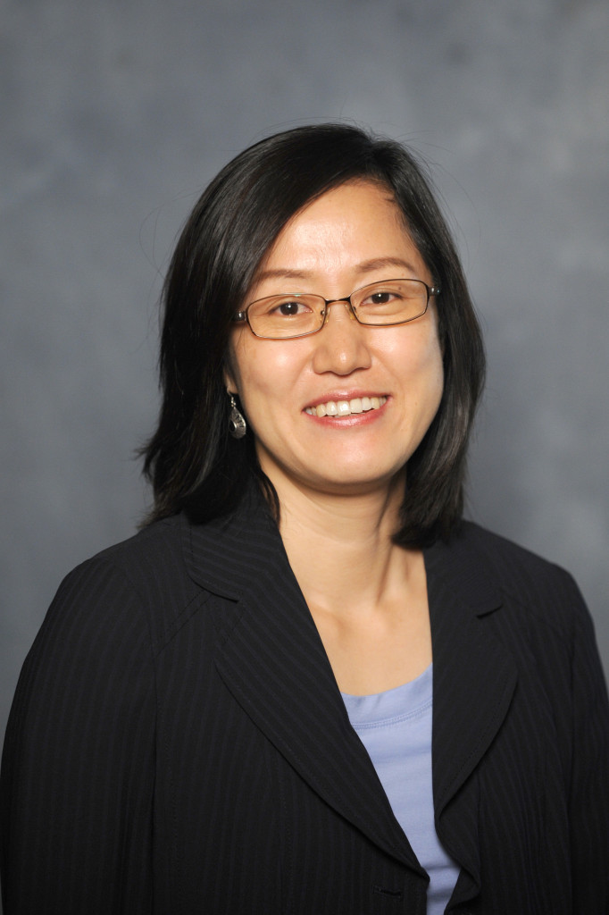 Georgia Athletic Association Professor in Family and Consumer Sciences Jung Lee smiles against a gray background in her professional headshot.