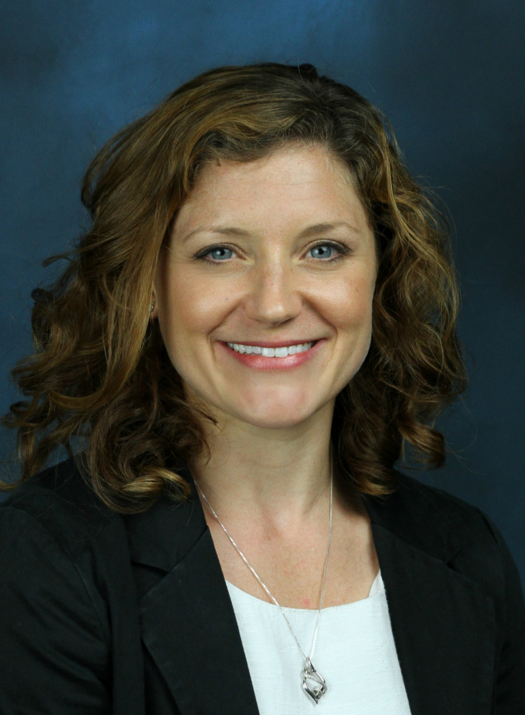Ali Berg smiles in her professional headshot