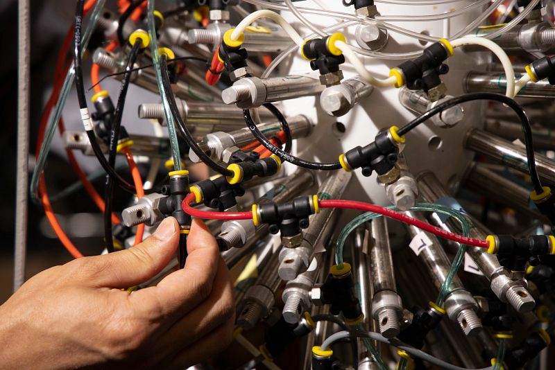 Detail of Fanbin Kong’s hand as he works with a gastric simulation model in his laboratory.