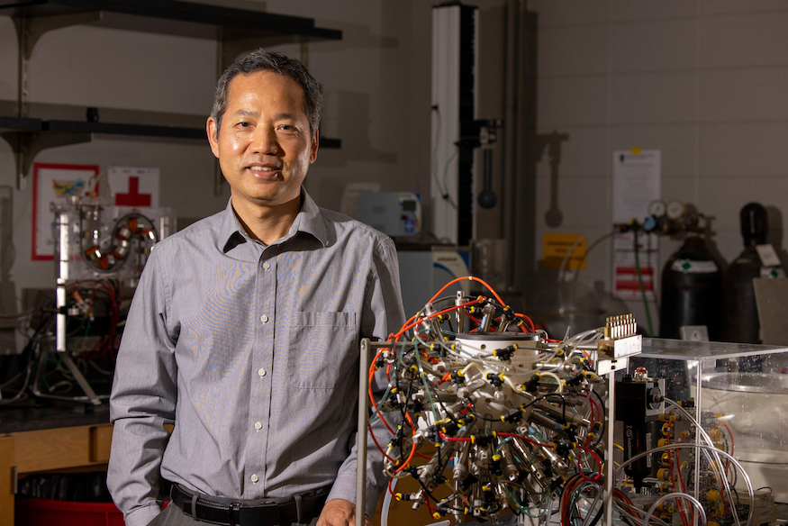 Fanbin Kong with a gastric simulation model in his laboratory in the UGA Department of Food Science and Technology.
