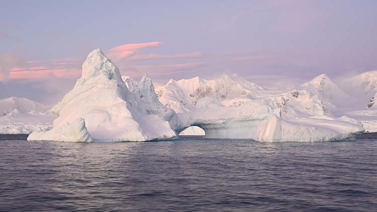 An arched iceberg along the Antarctic Peninsula, taken June 17, 2022. Last month Antarctic sea ice extent reached a record low for June, at 4.68 million square miles — or about 471,000 square miles below average. (Dan Costa/National Science Foundation/Creative Commons: https://creativecommons.org/licenses/by-nc-nd/4.0/)