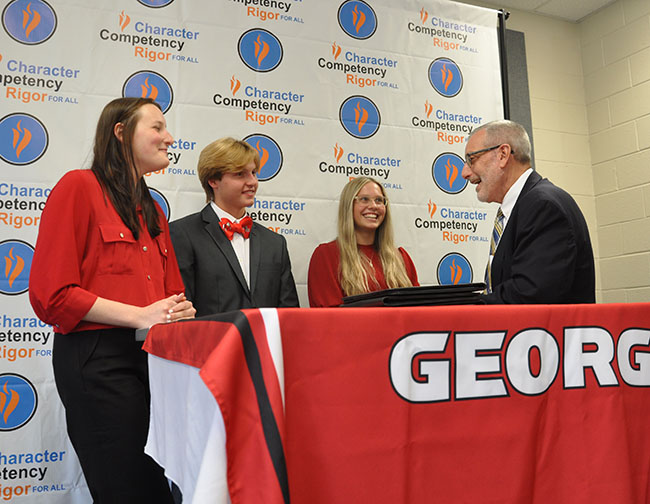 Hall County high school students Chloe Mottz, Walker Barrett and Ayden Plumlee chat with CAES Dean Nick T. Place at the signing ceremony for the CAES-IRSP partnership.