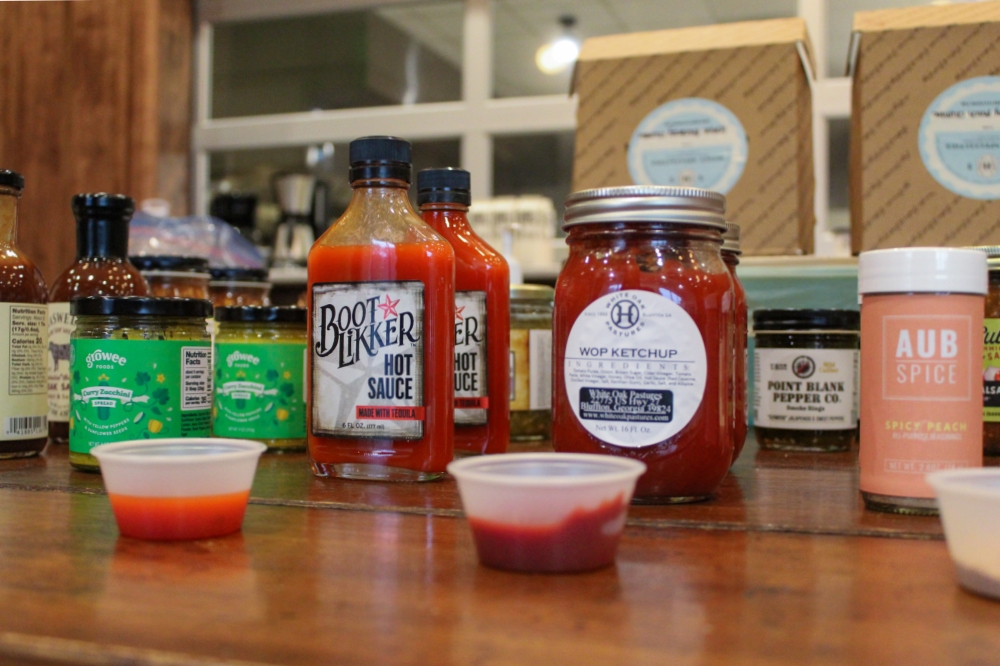 Jars of submitted sauces and plastic ramekins sit on the judging table