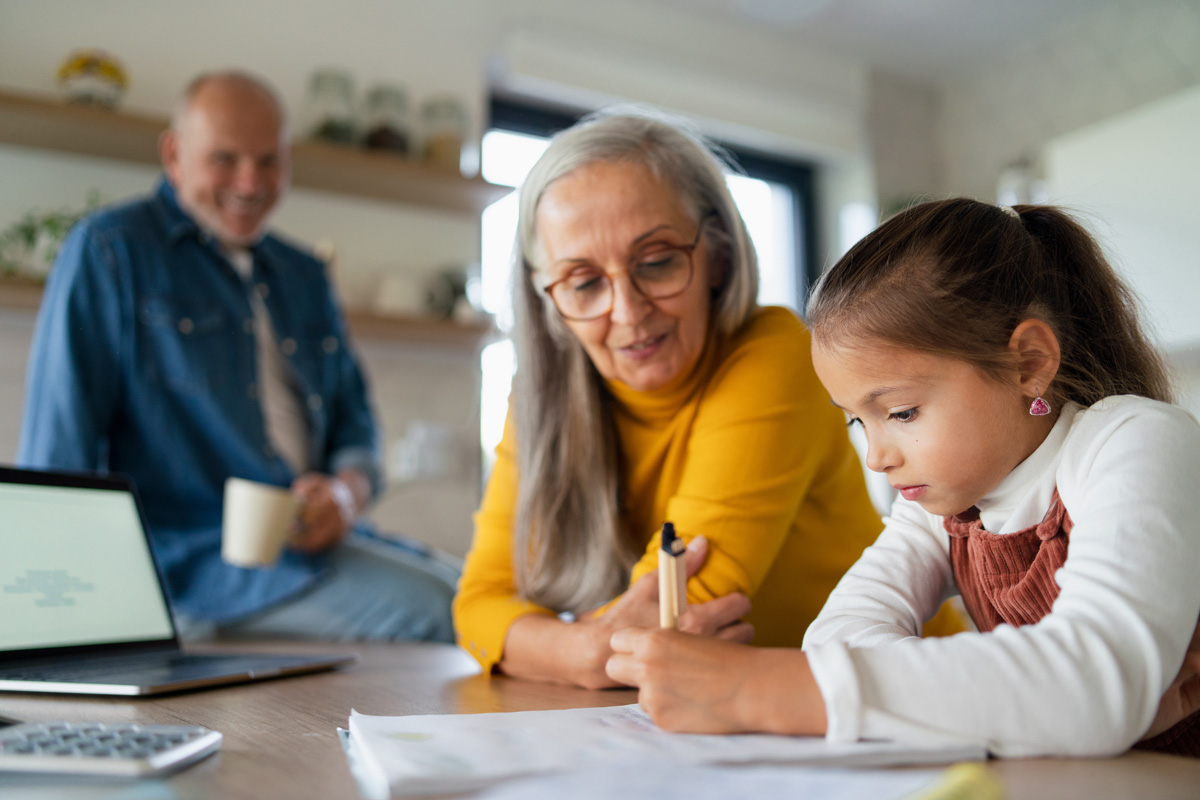 Grandparent helping grandchild with homework.