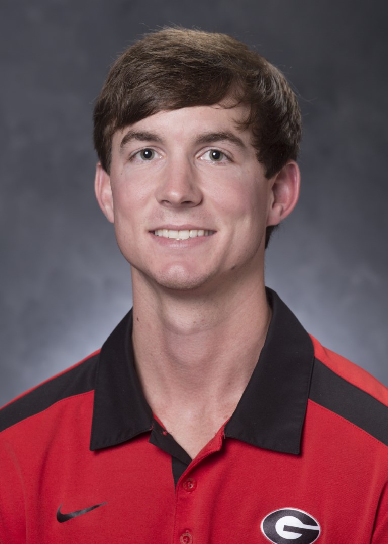 Ty Torrance smiles in a UGA collared shirt