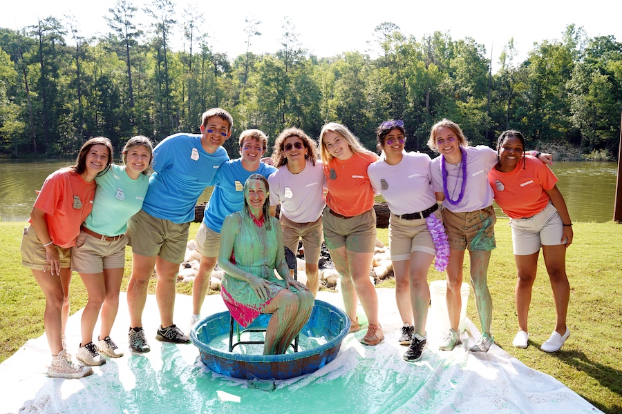 The 2022-2023 Georgia 4-H student board poses with green slime-covered Georgia 4-H Leader Melanie Biersmith after the 2023 $4 for 4-H celebration.
