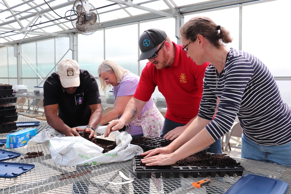 Attendees during a hands-on greenhouse workshop