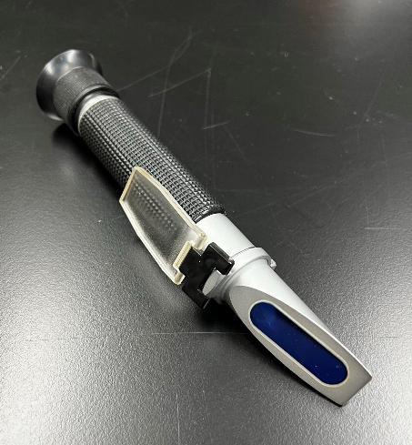 An analog refractometer is a cylindrical tool with a tapered end.