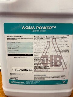 A close-up of an Aqua Power brand liquid fertilizer's label.