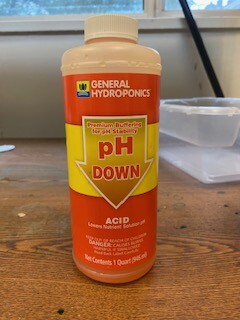 an orange bottle with yellow labeling reads ph down