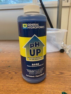 a blue bottle with yellow labeling reads ph up