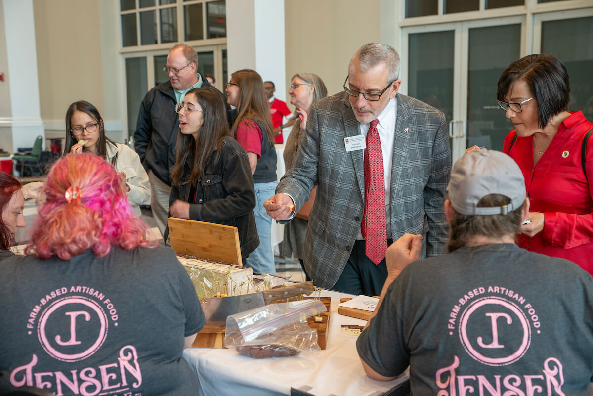 Attendees, including Dean Nick Place, trying samples from the various finalists at the Flavor of Georgia contest.