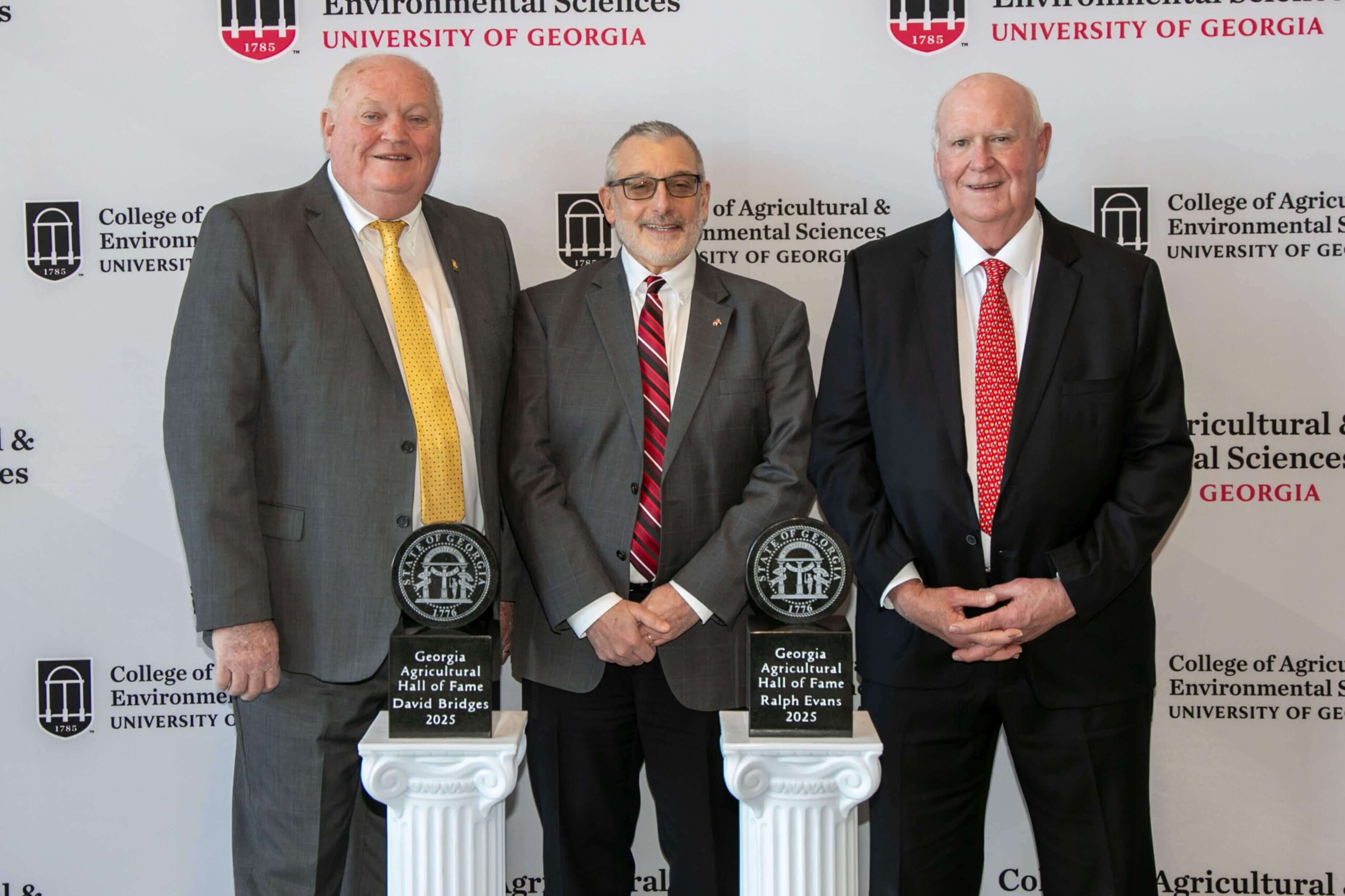 2025 Georgia Agricultural Hall of Fame inductees David Bridges and Ralph Evans gather with CAES Dean Nick Place at the awards ceremony.